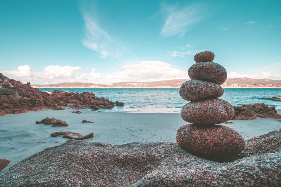 massage peaceful stacked rocks on beach